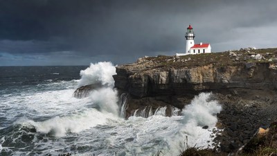 Lighthouse on Cliff with Crashing Waves