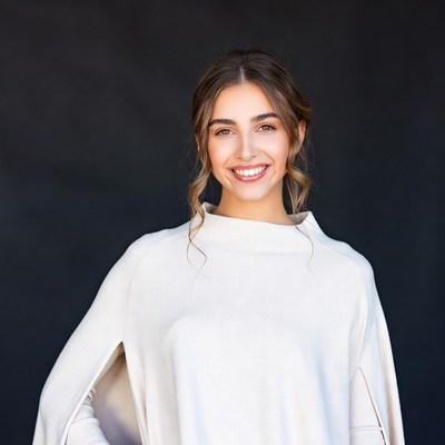 Smiling woman in white off-shoulder top
