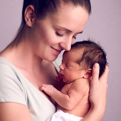 Mother kissing newborn baby