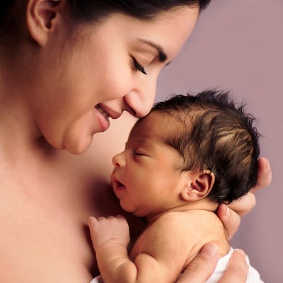 Mother kissing newborn baby