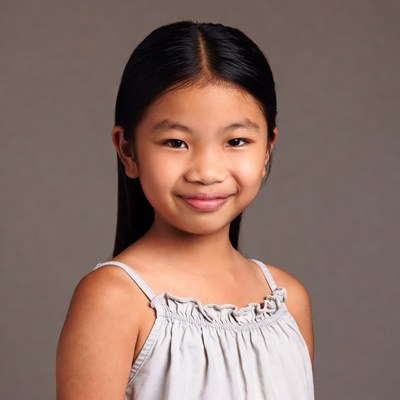Asian girl smiling in white dress