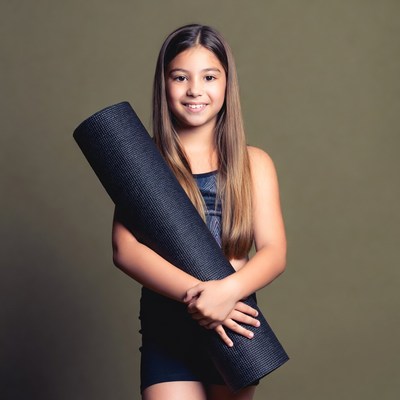Girl holding yoga mat