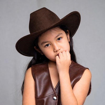 Asian girl in cowboy hat and vest