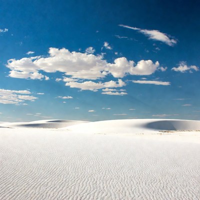 White sand dunes under blue sky