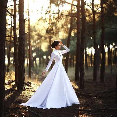 Woman in white gown in pine forest