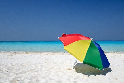 Colorful beach umbrella on sand