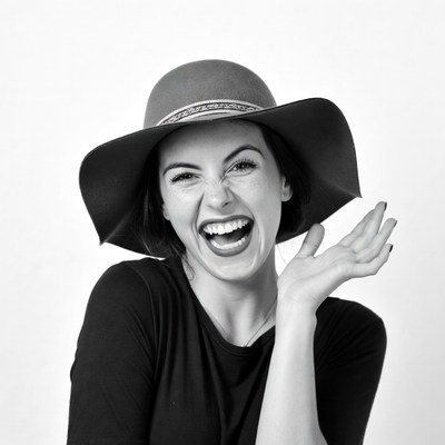 Woman laughing in wide-brim hat