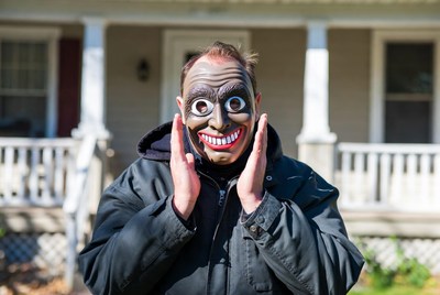 Man wearing creepy Halloween mask