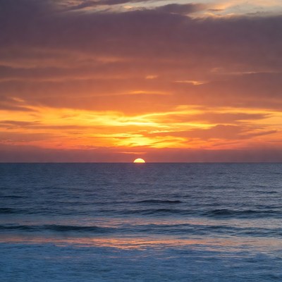 Sunset over ocean waves
