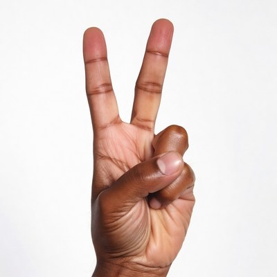 Dark-skinned hand making peace sign
