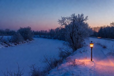 Street Lamp Illuminating Snowy Riverbank