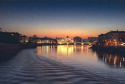 Lit Bridge Over River at Twilight