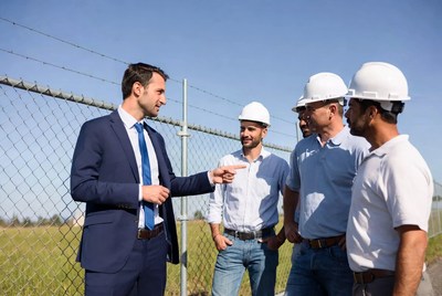 Businessman discussing with construction workers