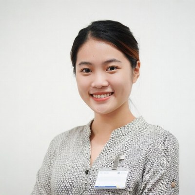 Asian woman in uniform with ID badge