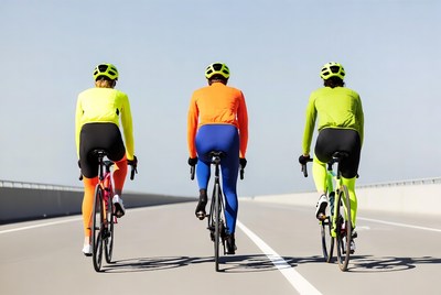 Three cyclists riding bikes on bridge