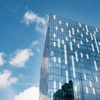 Modern Glass Skyscraper Against Blue Sky