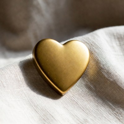 Gold heart on beige fabric