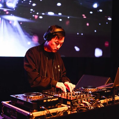 Asian man DJing at nightclub