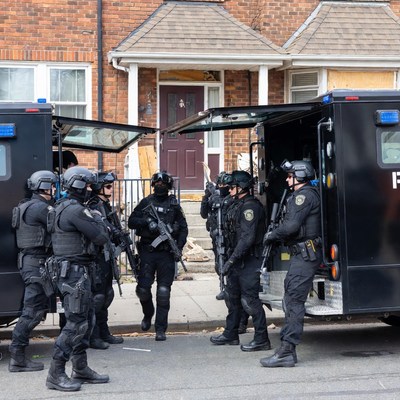 SWAT team gathering near armored vehicles