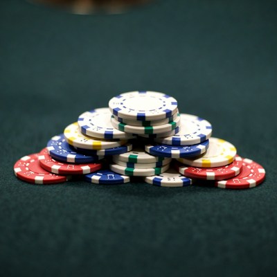 Colorful poker chips stack on green felt