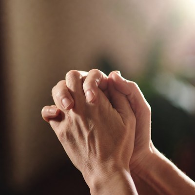 Hands clasped in prayer