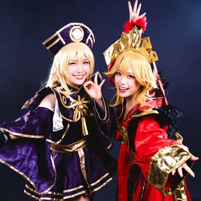 Two women in gold cosplay costumes posing