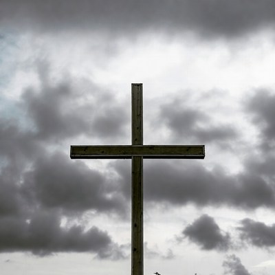 Wooden Cross Against Stormy Clouds