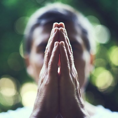 Person praying with hands together