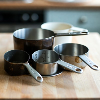 Assorted Measuring Cups on Wooden Counter