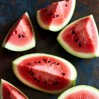 Fresh watermelon slices on rustic surface