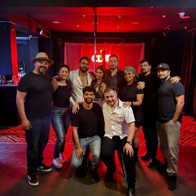 Group posing by pole dance stage