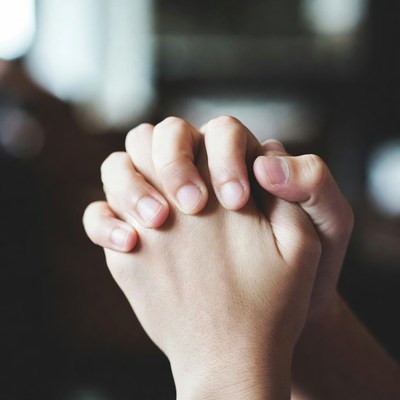 Hands clasped in prayer