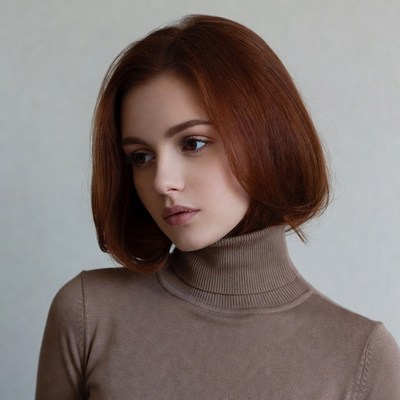 Redhead woman in turtleneck profile