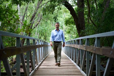 Man walking on forest footbridge