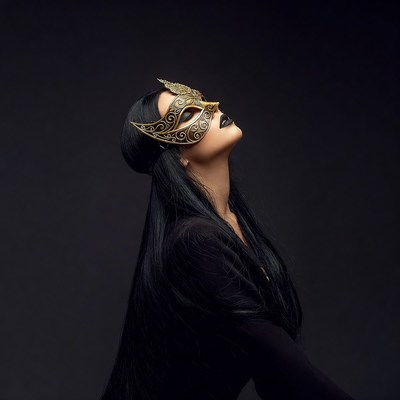 Woman wearing gold Venetian mask
