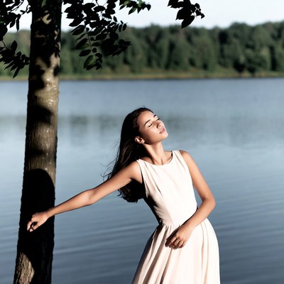 Asian woman in white dress by lake