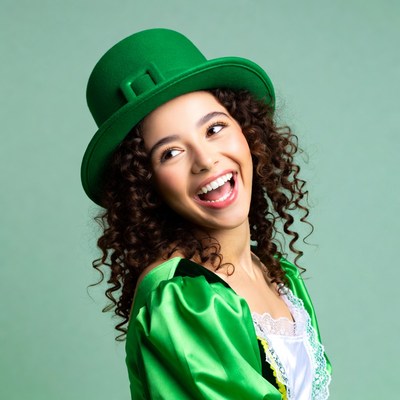 Smiling woman in green leprechaun hat