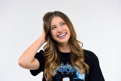 Smiling woman scratching head thoughtfully