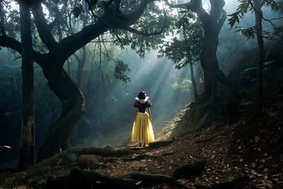 Snow White walking in enchanted forest