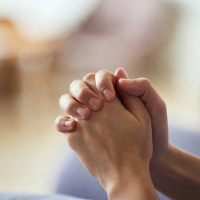 Hands clasped in prayer