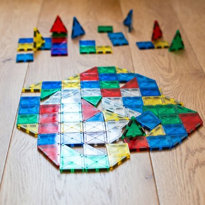 Colorful Magna-Tiles on Wooden Floor