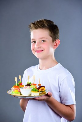 Boy holding plate of appetizers