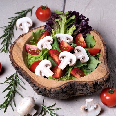 Fresh Tomato Mushroom Salad in Wooden Bowl