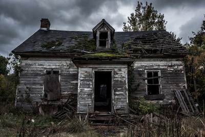 Abandoned haunted house in stormy woods