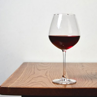 Glass of red wine on table
