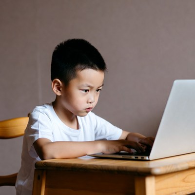 Asian boy using laptop