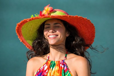 Woman smiling in colorful wide-brim hat