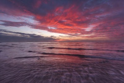 Vibrant Red Sunset Over Ocean Waves