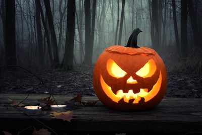 Jack-o'-lantern in foggy forest