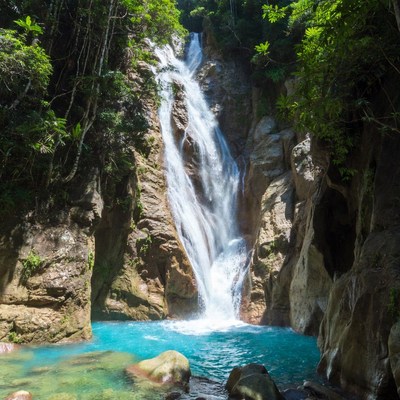 Tropical Waterfall Cascading into Turquoise Pool